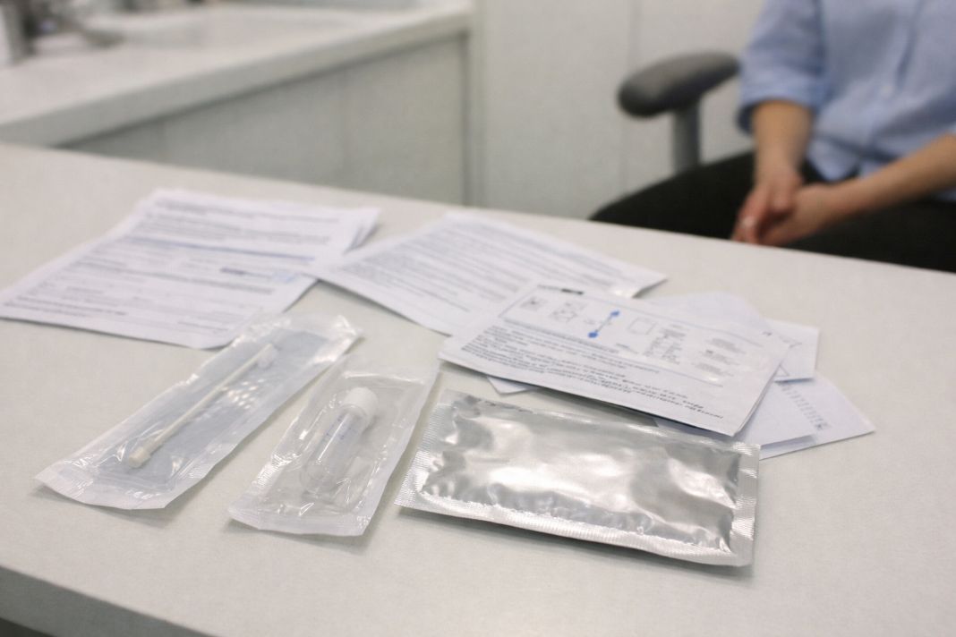 An illustrative photo of sti testing kit laid out on a medical clinic table An illustrative photo of sti testing kit laid out on a medical clinic table