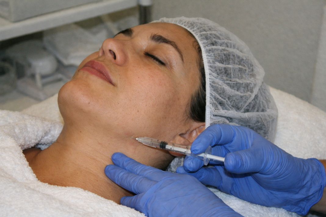 an illustrative photo of a lady receiving treatment in a clinic setting an illustrative photo of a lady receiving treatment in a clinic setting